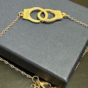 Add-on to any bundle $5. Golden handcuff bracelet. Says “freedom”.